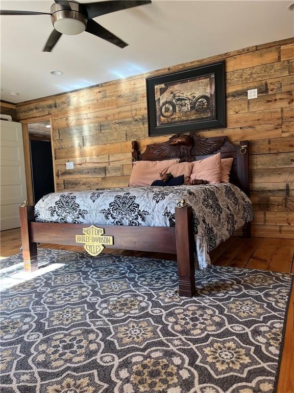 bedroom featuring wood walls and wood finished floors