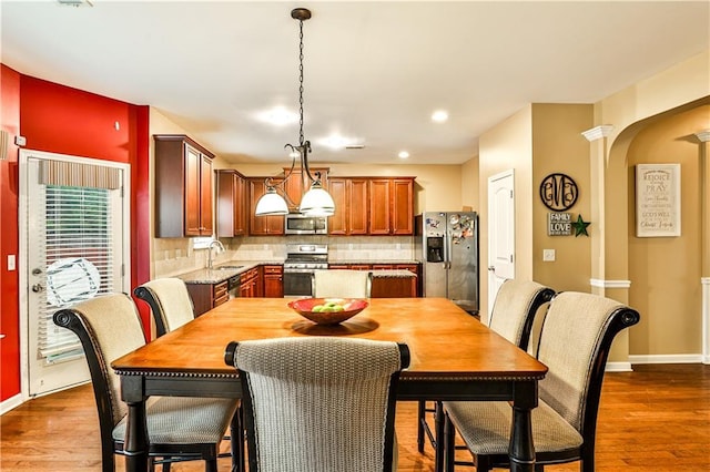 dining room featuring sink and dark wood-type flooring