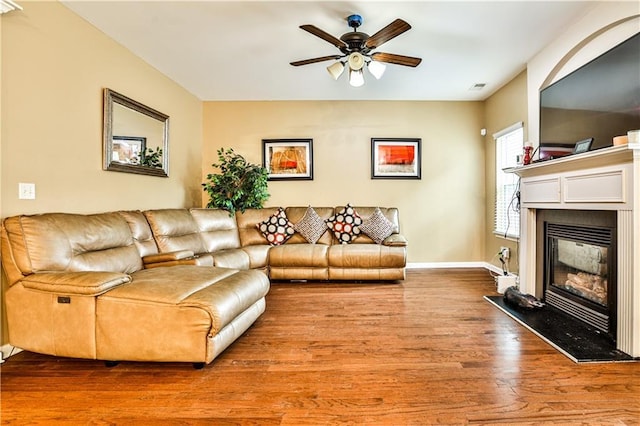 living room featuring hardwood / wood-style flooring and ceiling fan