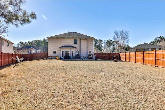 back of house featuring a yard