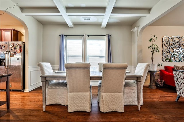 dining space featuring coffered ceiling, dark hardwood / wood-style floors, and beamed ceiling