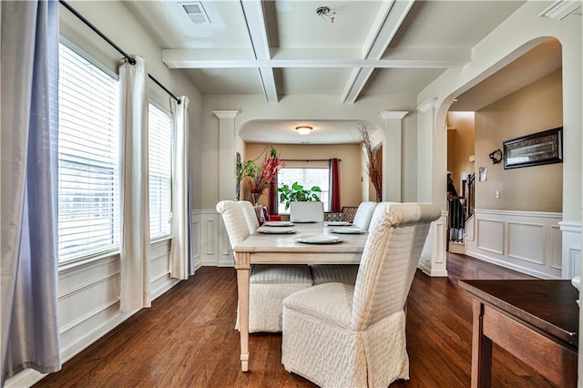 dining area with beamed ceiling, coffered ceiling, dark hardwood / wood-style floors, and ornate columns