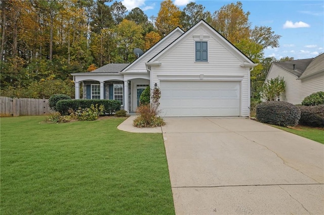 view of front of home with a garage and a front lawn