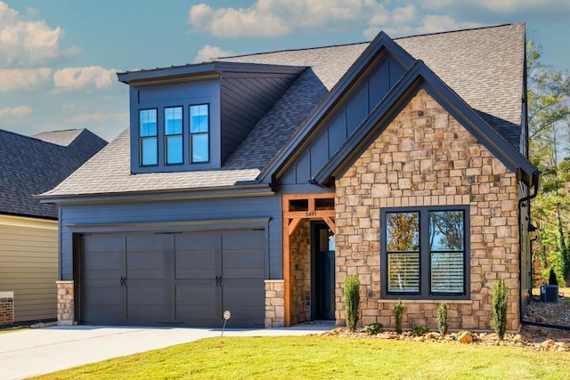 view of front of home with a front yard and a garage