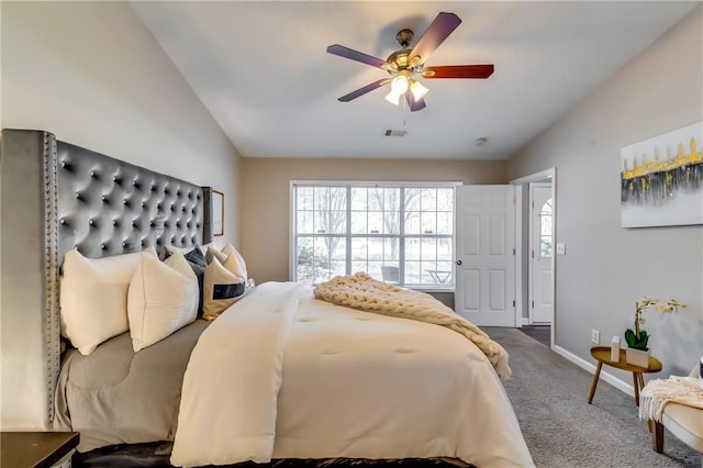 carpeted bedroom featuring lofted ceiling, baseboards, visible vents, and a ceiling fan