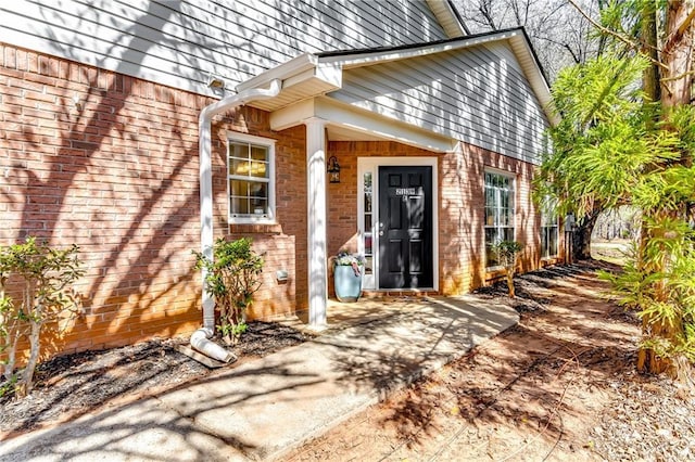 entrance to property with brick siding