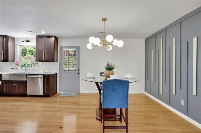 6914 Fairway Trl, Austell, GA 30168 - dining space featuring visible vents, baseboards, a chandelier, and light wood-type flooring