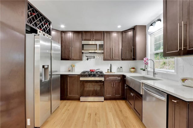 6914 Fairway Trl, Austell, GA 30168 - kitchen with decorative backsplash, light countertops, a sink, and stainless steel appliances
