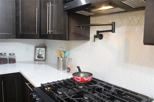 6914 Fairway Trl, Austell, GA 30168 - kitchen with light stone countertops, tasteful backsplash, dark brown cabinetry, and extractor fan