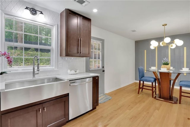 6914 Fairway Trl, Austell, GA 30168 - kitchen with a chandelier, stainless steel dishwasher, a sink, visible vents, and light wood-style flooring