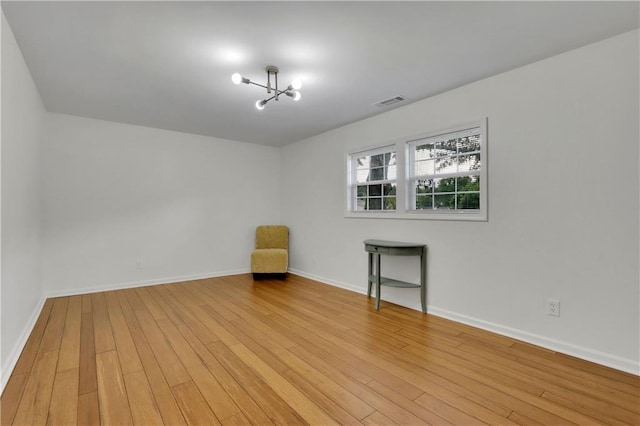 6914 Fairway Trl, Austell, GA 30168 - spare room featuring baseboards, visible vents, a chandelier, and light wood finished floors