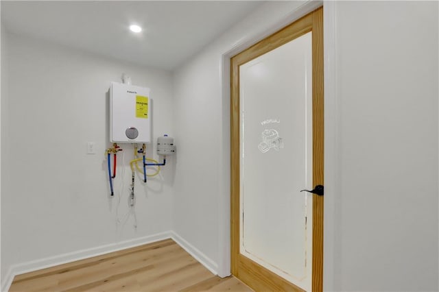 6914 Fairway Trl, Austell, GA 30168 - hallway featuring light wood finished floors, baseboards, and tankless water heater