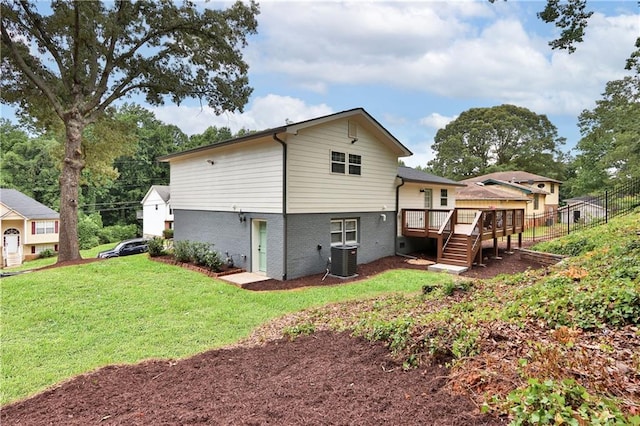 6914 Fairway Trl, Austell, GA 30168 - rear view of property with fence, a deck, brick siding, a lawn, and cooling unit