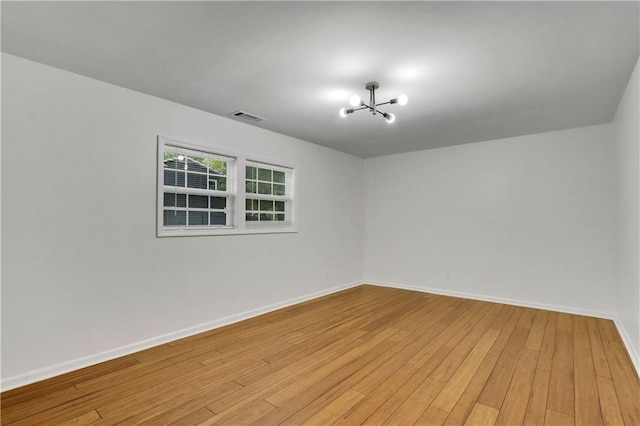 6914 Fairway Trl, Austell, GA 30168 - empty room featuring baseboards, light wood-style floors, a chandelier, and visible vents