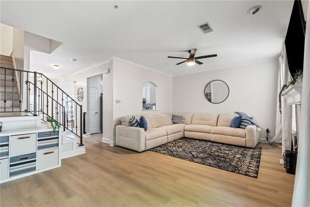 3088 Steeplechase Dr, Alpharetta, GA 30004 - living area featuring ceiling fan, visible vents, crown molding, stairway, and light wood finished floors