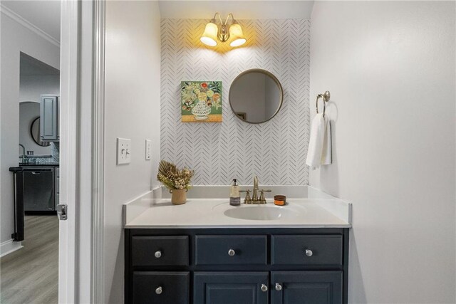 3088 Steeplechase Dr, Alpharetta, GA 30004 - bathroom featuring vanity, wood finished floors, an accent wall, baseboards, and wallpapered walls