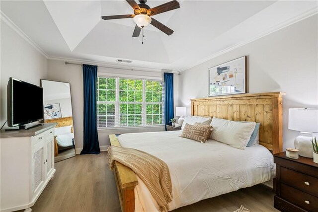 3088 Steeplechase Dr, Alpharetta, GA 30004 - bedroom with visible vents, a raised ceiling, light wood-style flooring, and crown molding