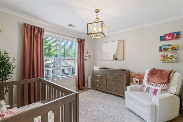 3088 Steeplechase Dr, Alpharetta, GA 30004 - bedroom with crown molding, a nursery area, baseboards, and an inviting chandelier