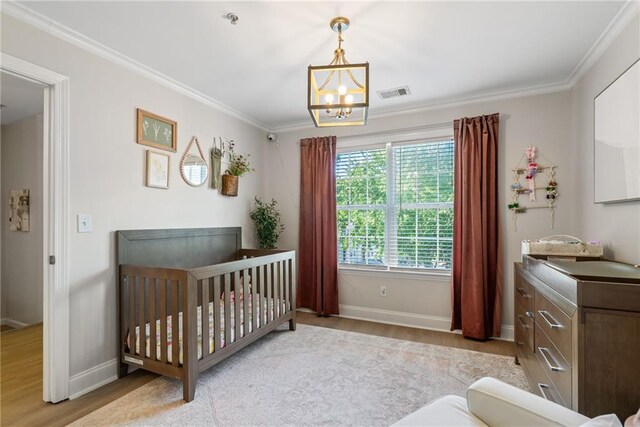 3088 Steeplechase Dr, Alpharetta, GA 30004 - bedroom featuring visible vents, wood finished floors, baseboards, a crib, and ornamental molding