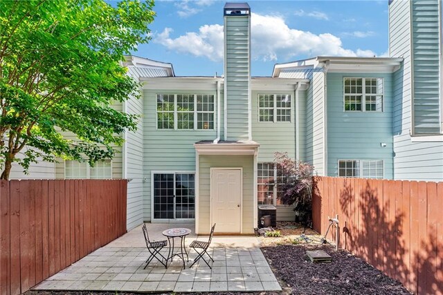 3088 Steeplechase Dr, Alpharetta, GA 30004 - rear view of house featuring a patio, fence, and a chimney