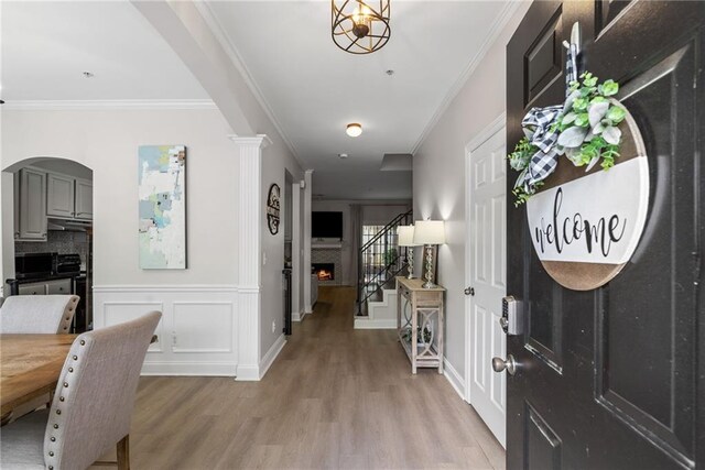 3088 Steeplechase Dr, Alpharetta, GA 30004 - corridor with crown molding, arched walkways, light wood-type flooring, and stairs