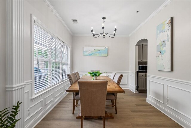 3088 Steeplechase Dr, Alpharetta, GA 30004 - dining area featuring an inviting chandelier, visible vents, ornamental molding, a decorative wall, and arched walkways