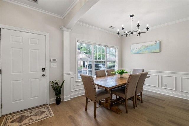 3088 Steeplechase Dr, Alpharetta, GA 30004 - dining area featuring visible vents, wood finished floors, a chandelier, ornamental molding, and ornate columns