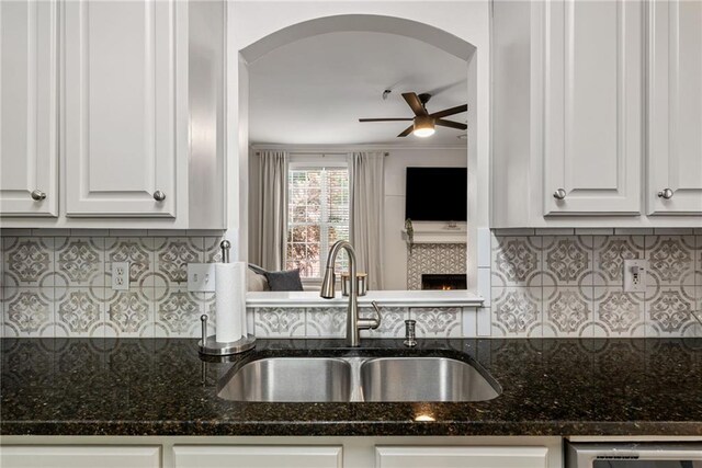 3088 Steeplechase Dr, Alpharetta, GA 30004 - kitchen featuring backsplash, arched walkways, ceiling fan, and a sink