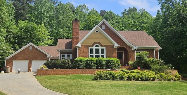 view of front of house featuring driveway, a chimney, a garage, brick siding, and a front lawn