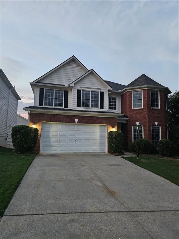 front facade featuring a garage and a front yard