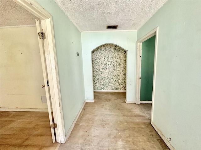 hallway with a textured ceiling