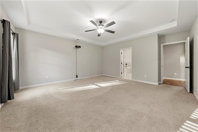 unfurnished living room featuring ceiling fan, a brick fireplace, a towering ceiling, and light wood-type flooring