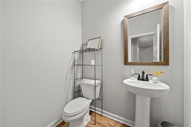 bathroom featuring hardwood / wood-style floors, sink, and toilet