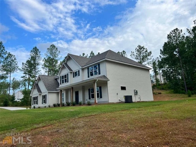 view of front of house featuring central AC unit and a front yard