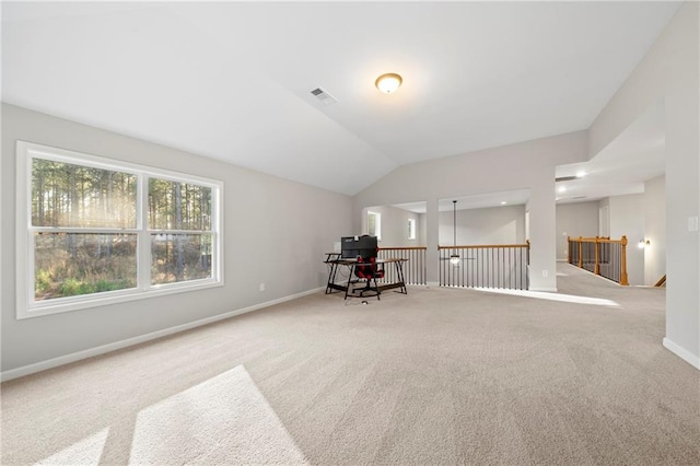 home office with vaulted ceiling and carpet floors