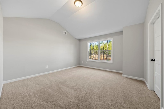 unfurnished bedroom with lofted ceiling and light colored carpet