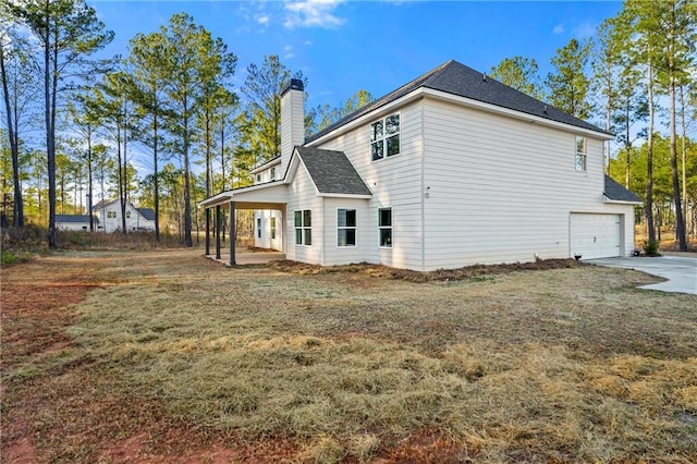 exterior space with a garage and a lawn