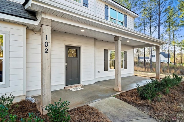 view of exterior entry with covered porch