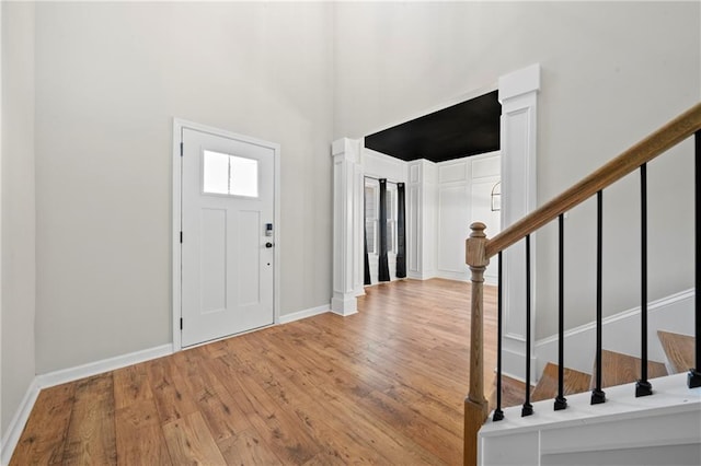 foyer featuring light hardwood / wood-style floors and a high ceiling