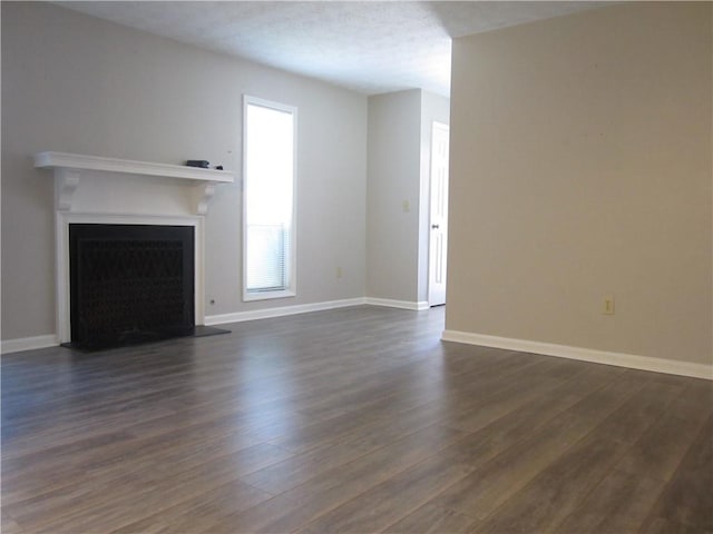 4018 Woodridge Way, Tucker, GA 30084 - unfurnished living room with a fireplace, baseboards, and dark wood-style floors