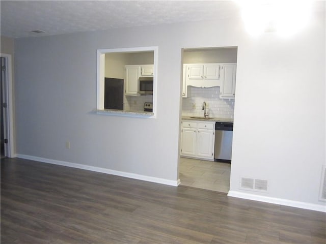 4018 Woodridge Way, Tucker, GA 30084 - interior space featuring a sink, baseboards, dark wood-type flooring, and visible vents