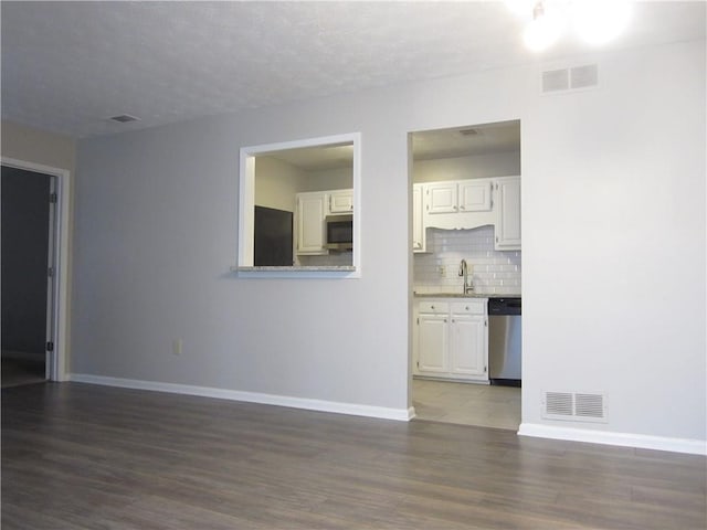 4018 Woodridge Way, Tucker, GA 30084 - unfurnished living room featuring baseboards, visible vents, and wood finished floors