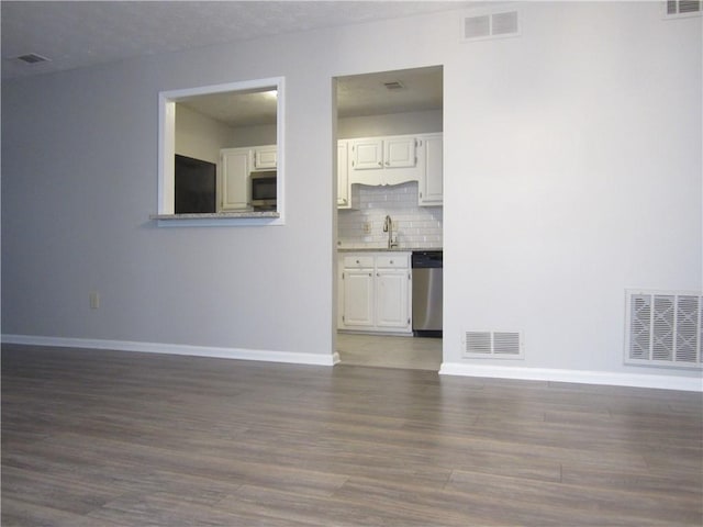 4018 Woodridge Way, Tucker, GA 30084 - unfurnished living room with visible vents, wood finished floors, and baseboards