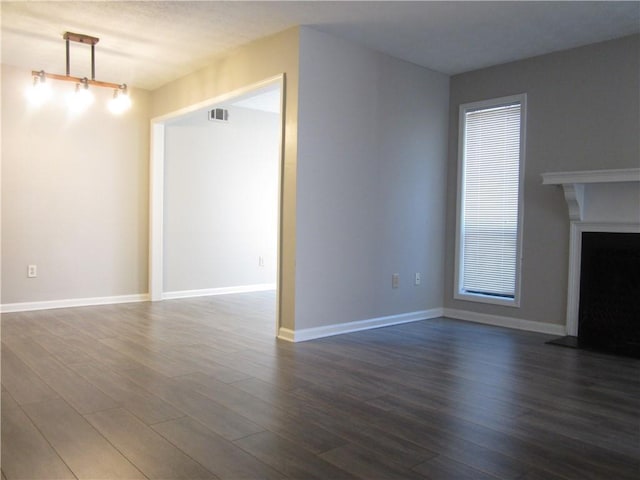 4018 Woodridge Way, Tucker, GA 30084 - unfurnished living room with a fireplace with raised hearth, visible vents, wood finished floors, and baseboards