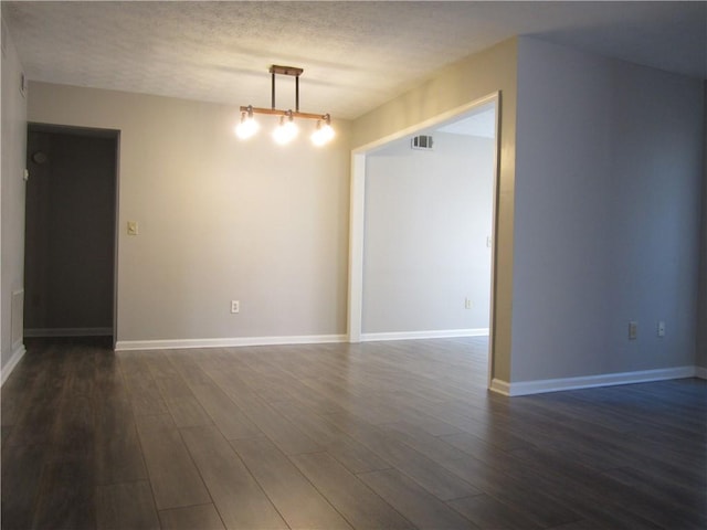 4018 Woodridge Way, Tucker, GA 30084 - unfurnished room featuring baseboards, a textured ceiling, visible vents, and dark wood-style floors