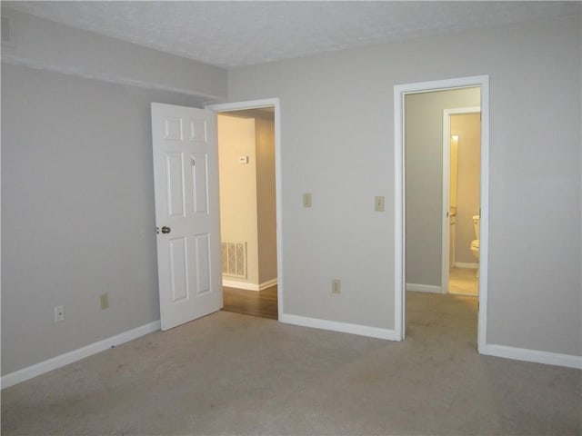 4018 Woodridge Way, Tucker, GA 30084 - unfurnished bedroom featuring carpet, a textured ceiling, visible vents, and baseboards