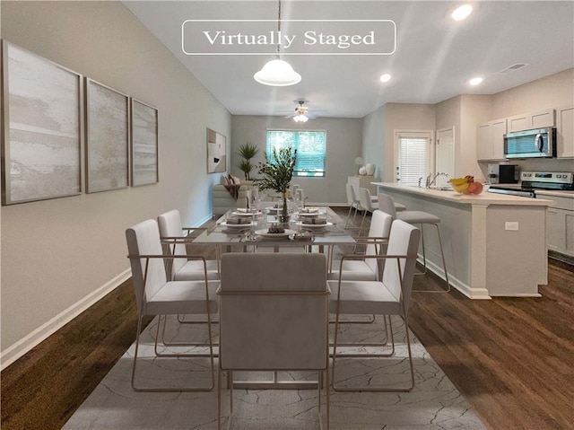 dining area with dark hardwood / wood-style floors