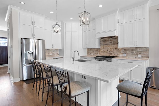 168 Brighton Blvd, Woodstock, GA 30188 - kitchen with stainless steel refrigerator with ice dispenser, a sink, a chandelier, dark wood-style floors, and range