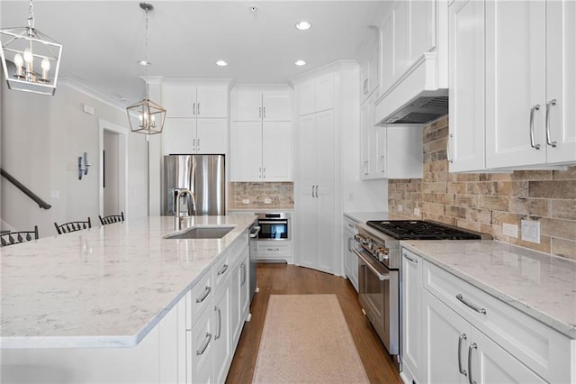 168 Brighton Blvd, Woodstock, GA 30188 - kitchen featuring appliances with stainless steel finishes, a sink, dark wood finished floors, premium range hood, and white cabinets