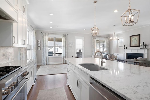 168 Brighton Blvd, Woodstock, GA 30188 - kitchen with a sink, a chandelier, stainless steel appliances, premium range hood, and crown molding
